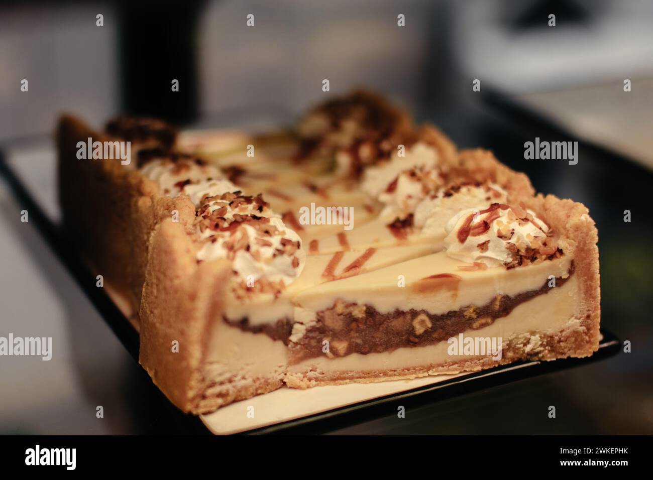 Sweet cheesecakes with caramel, nuts and cream topping Stock Photo Alamy