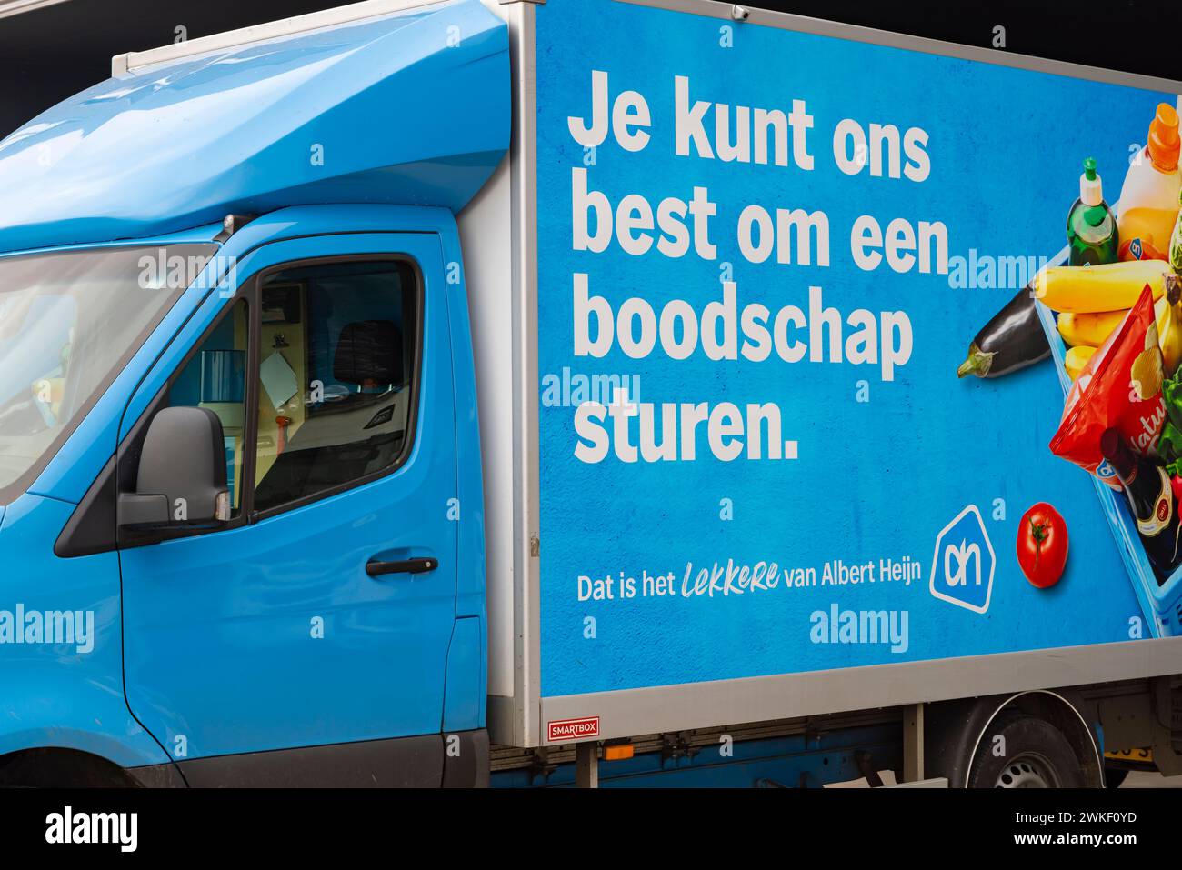 Ede, The Netherlands - February 11, 2024: Shopping delivery vans of Albert Heijn one of the biggest supermarket chain in The Netherlands Stock Photo