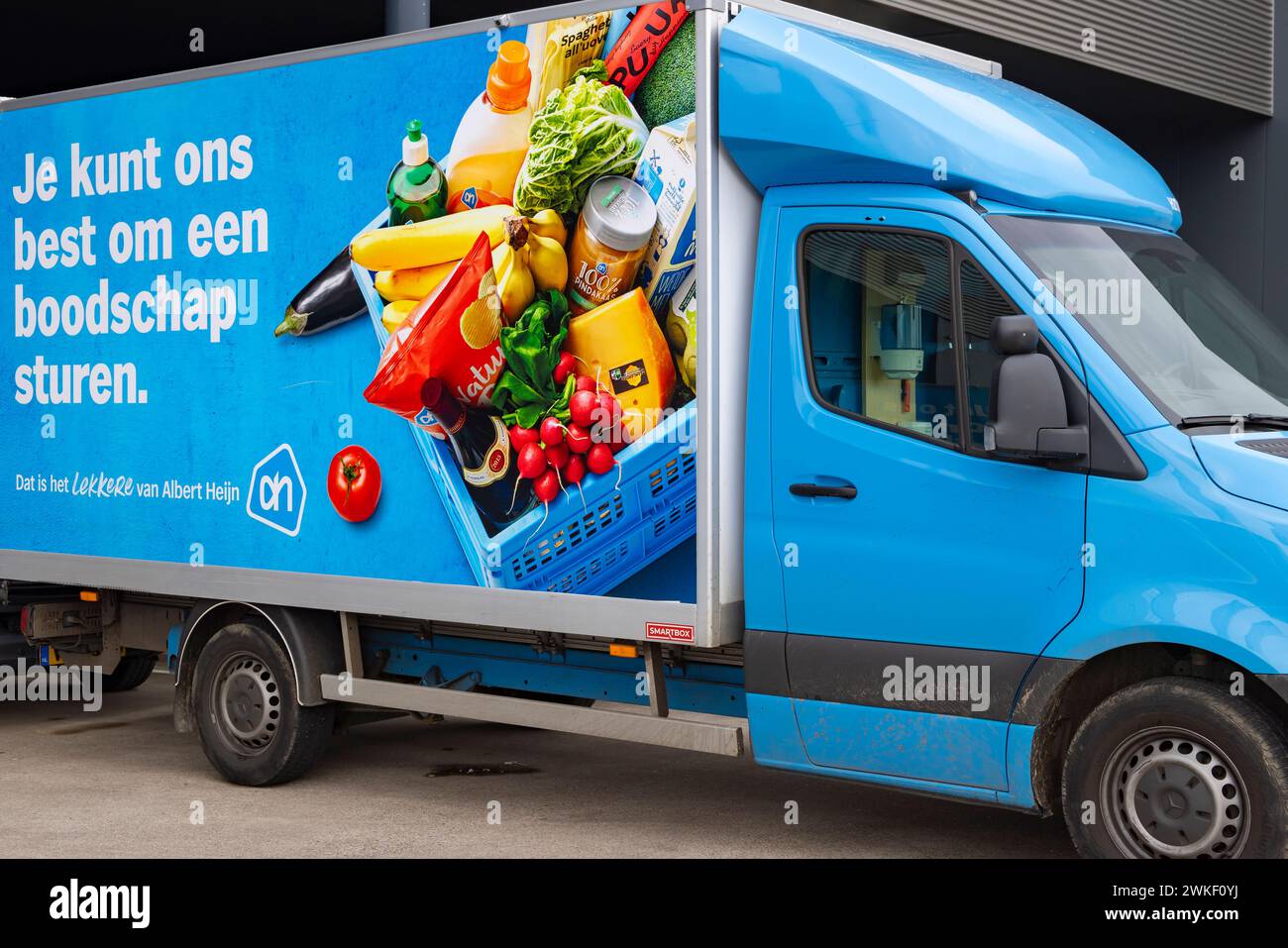 Ede, The Netherlands - February 11, 2024: Shopping delivery vans of Albert Heijn one of the biggest supermarket chain in The Netherlands Stock Photo