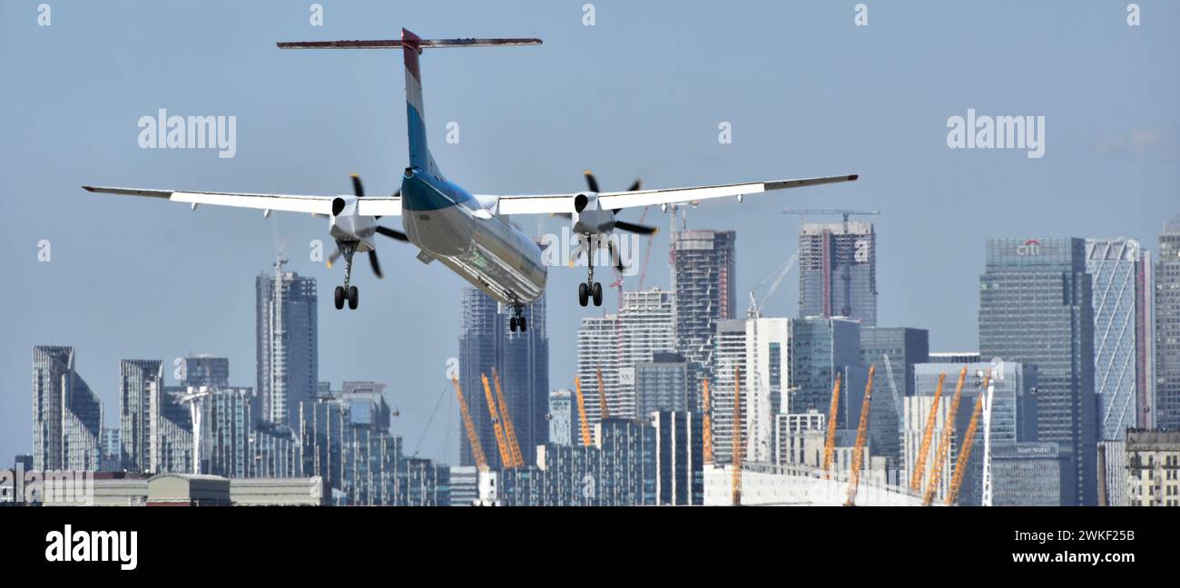 Luxair Bombardier DHC-8 Q400 LX-LGG Flybe turboprop plane landing London City Airport roof of O2 arena Canary Wharf skyline Tower Hamlets England UK Stock Photo