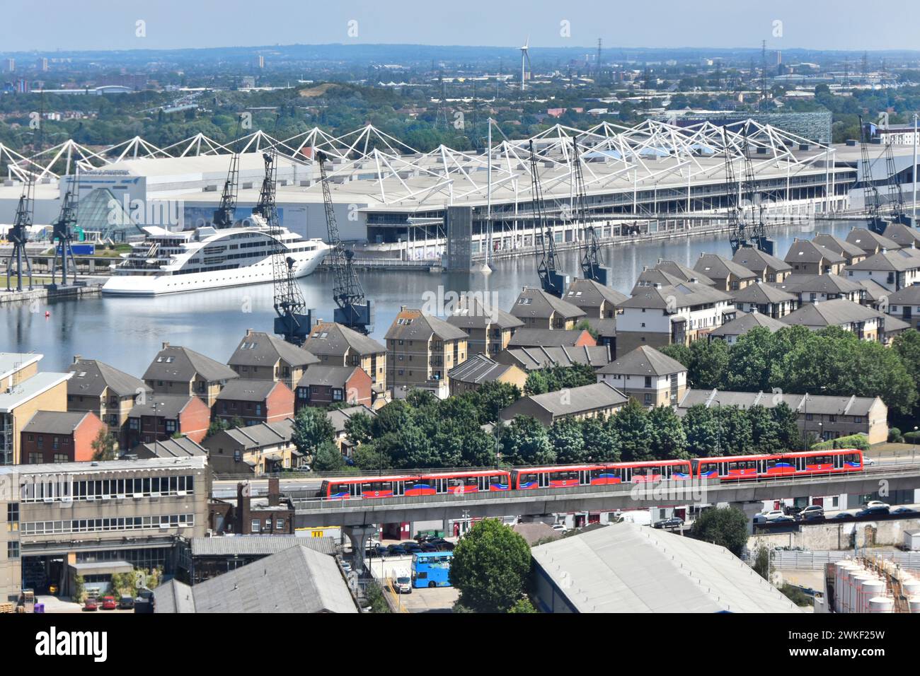 Docklands Light Railway train aerial view urban landscape Royal Victoria Dock & roof of Excel Exhibition Centre Silvertown East London  England UK Stock Photo