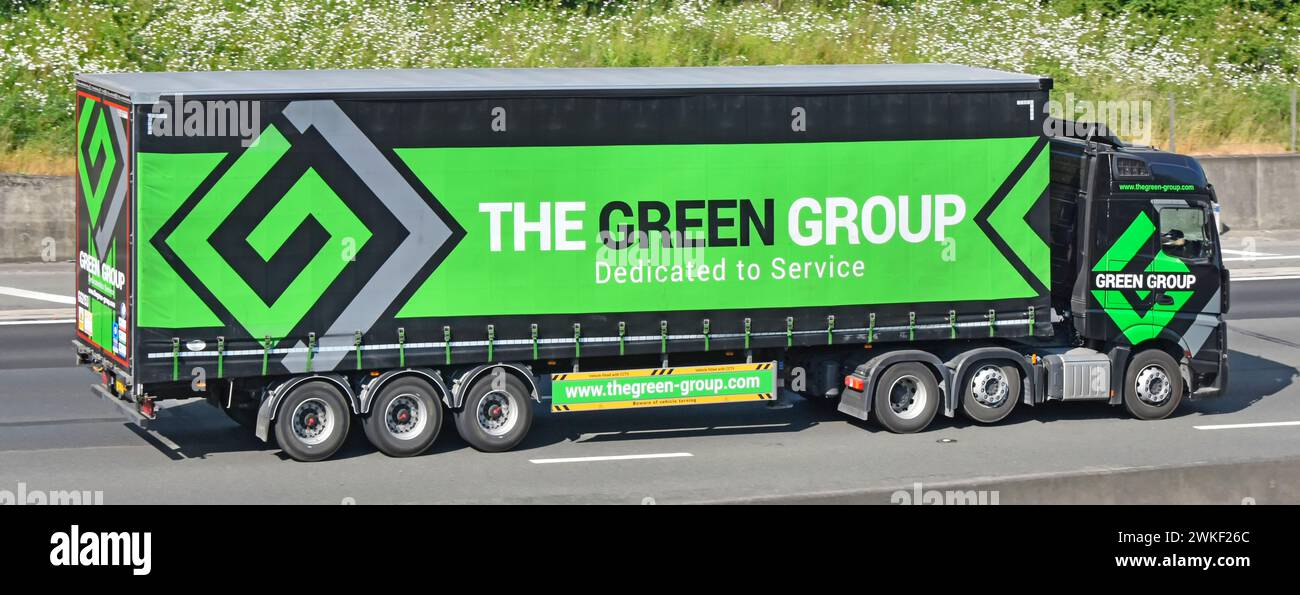 Green Group transport logistics business impact advertising colour graphic on Tautliner curtainsider hgv semi-trailer truck on M25 motorway England UK Stock Photo