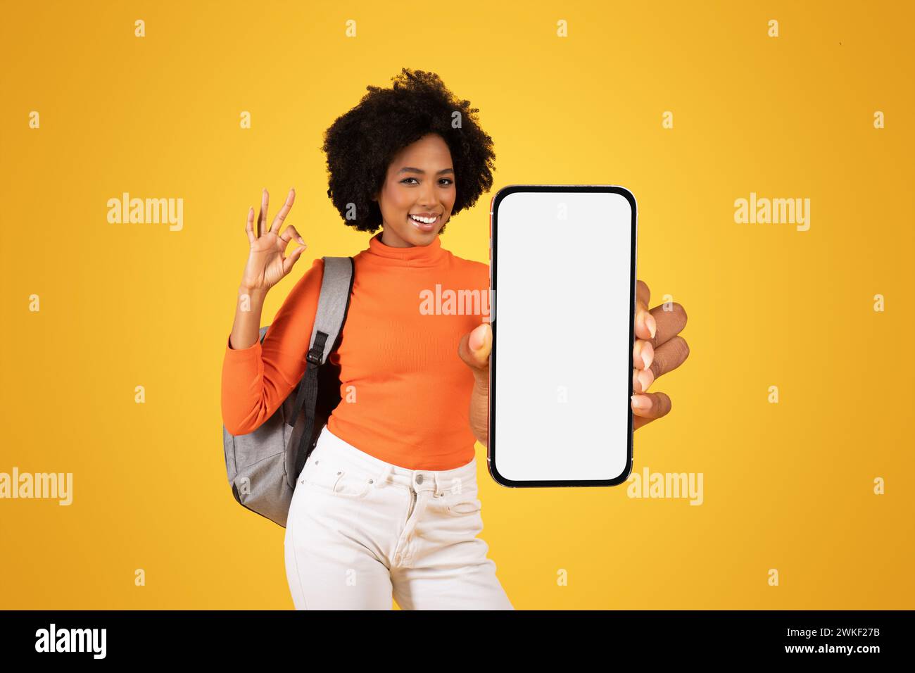 Happy African American woman with afro hair showing OK sign and ...