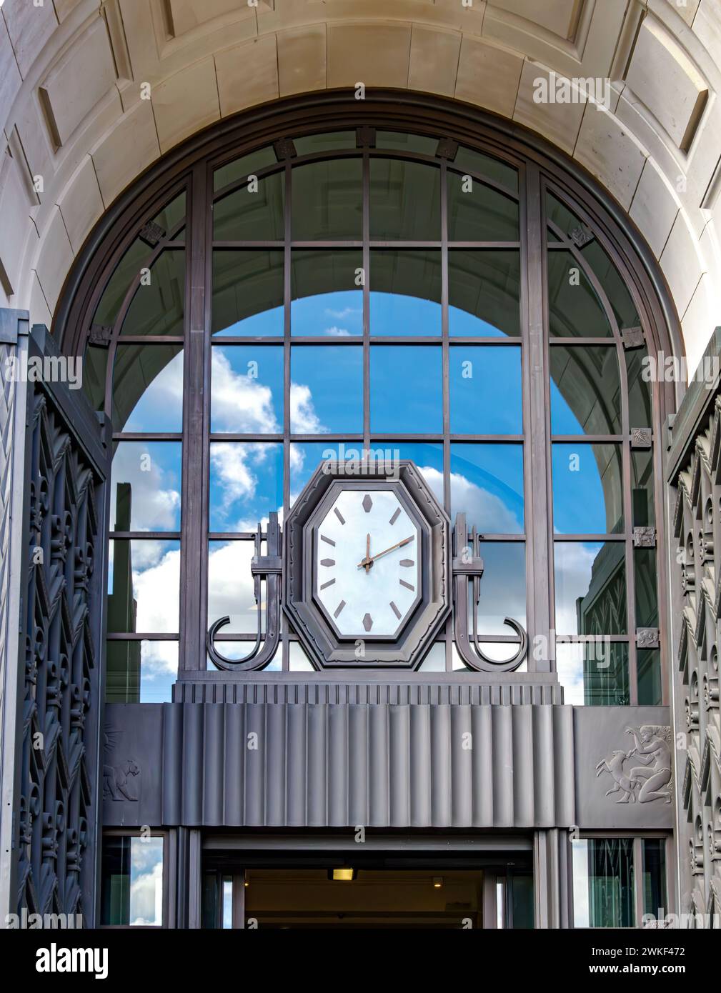 Art Deco style with clock and pewter panels by Eric Gill in the entrance arch to Unilever House by Blackfriars Bridge in the City of London UK Stock Photo