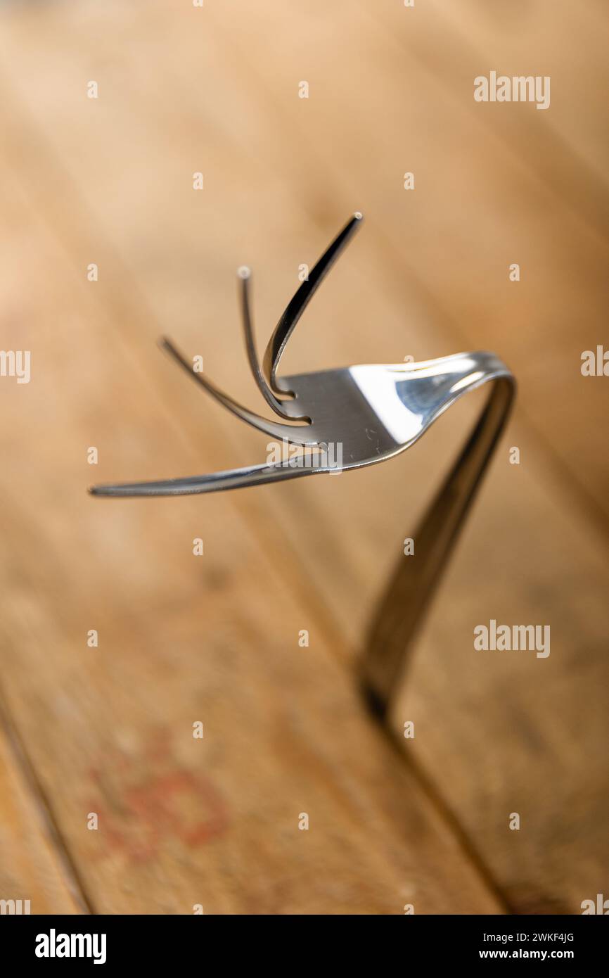 Art of Fork Bending, How to Bend Forks with Your Mind Stock Photo - Alamy
