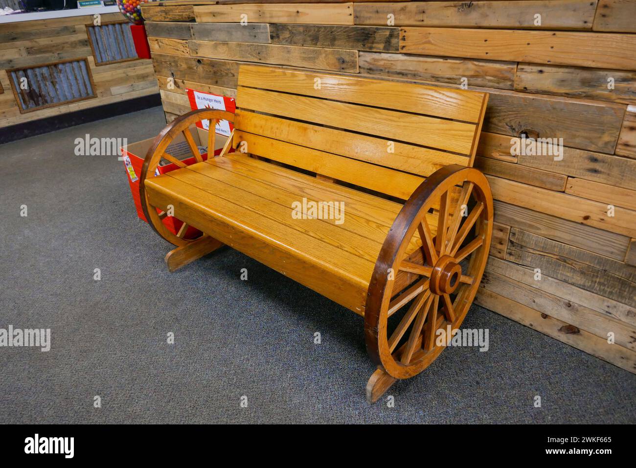 Wooden wagon wheel seat for customers to wait for their tables in a ...