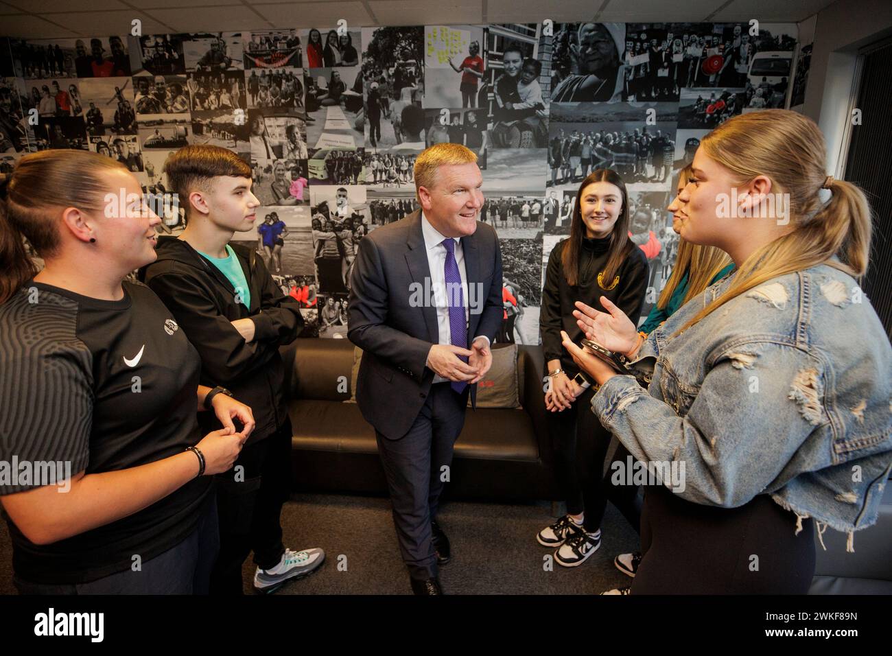 Irish Minister of Finance Michael McGrath (centre) speaking with young people at R-CITY Youth who are going through a leadership program with the cross community group, on Shankill Road in Belfast. The Irish Government unveiled an 800 million euro-plus (£683 million) funding package for Northern Ireland projects which will also benefit border counties and the Dublin-Belfast 'economic corridor'. Picture date: Tuesday February 20, 2024. Stock Photo