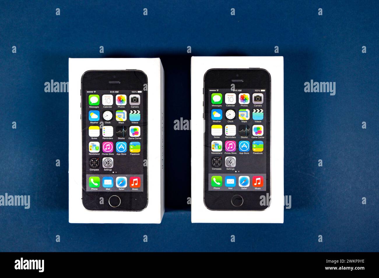 Apple iPhone 5 (s) boxes packaging on blue studio background Stock Photo