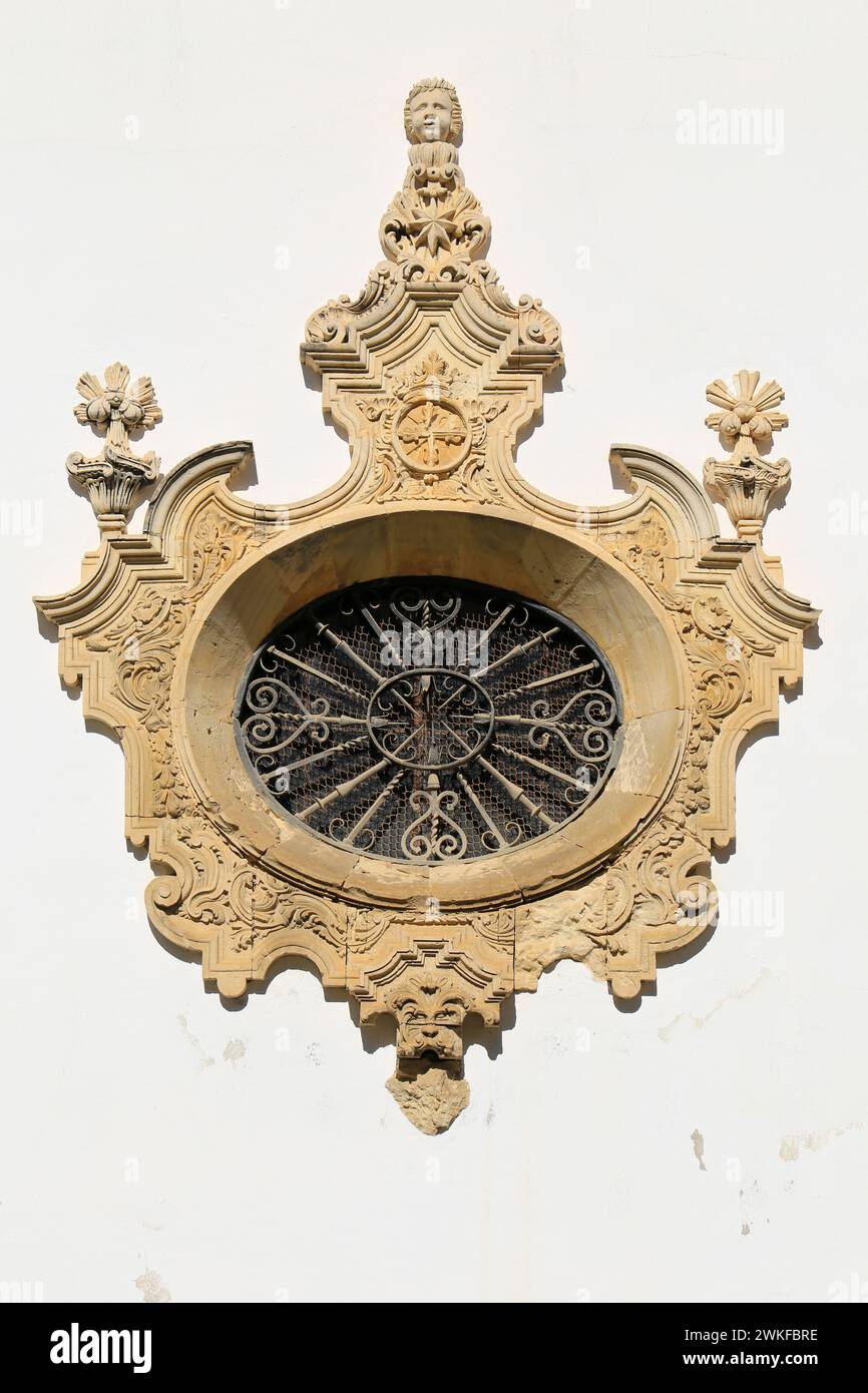 Old stone rosette with forged metal details in an old convent in Sanlucar de Barrameda, Cadiz Stock Photo