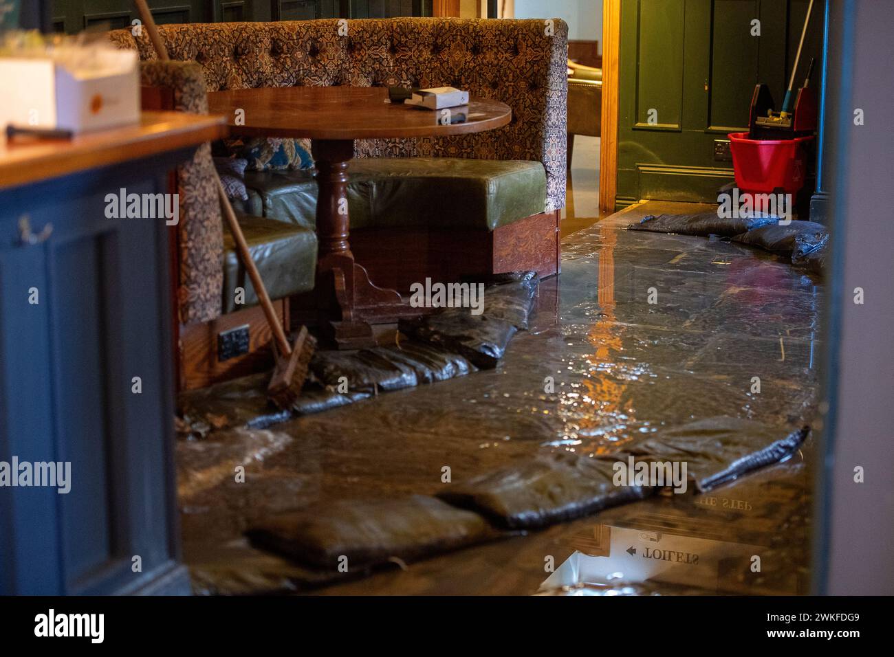 Chalfont St Peter, UK. 18th February, 2024. Groundwater from the River Misbourne has flooded up through the floor and into the pub toilets at the Greyhound Inn pub in the village of Chalfont St Peter. The pub has been forced to close. Thames Water have been outside the pub pumping away water for a number of weeks now. The flooding was worse again today following overnight rain. Although the area has flooded before, many locals believe the reason for the extensive flooding this time allegedly relates to HS2 who have been tunnelling underground in the region for the High Speed Rail. Credit: Maur Stock Photo