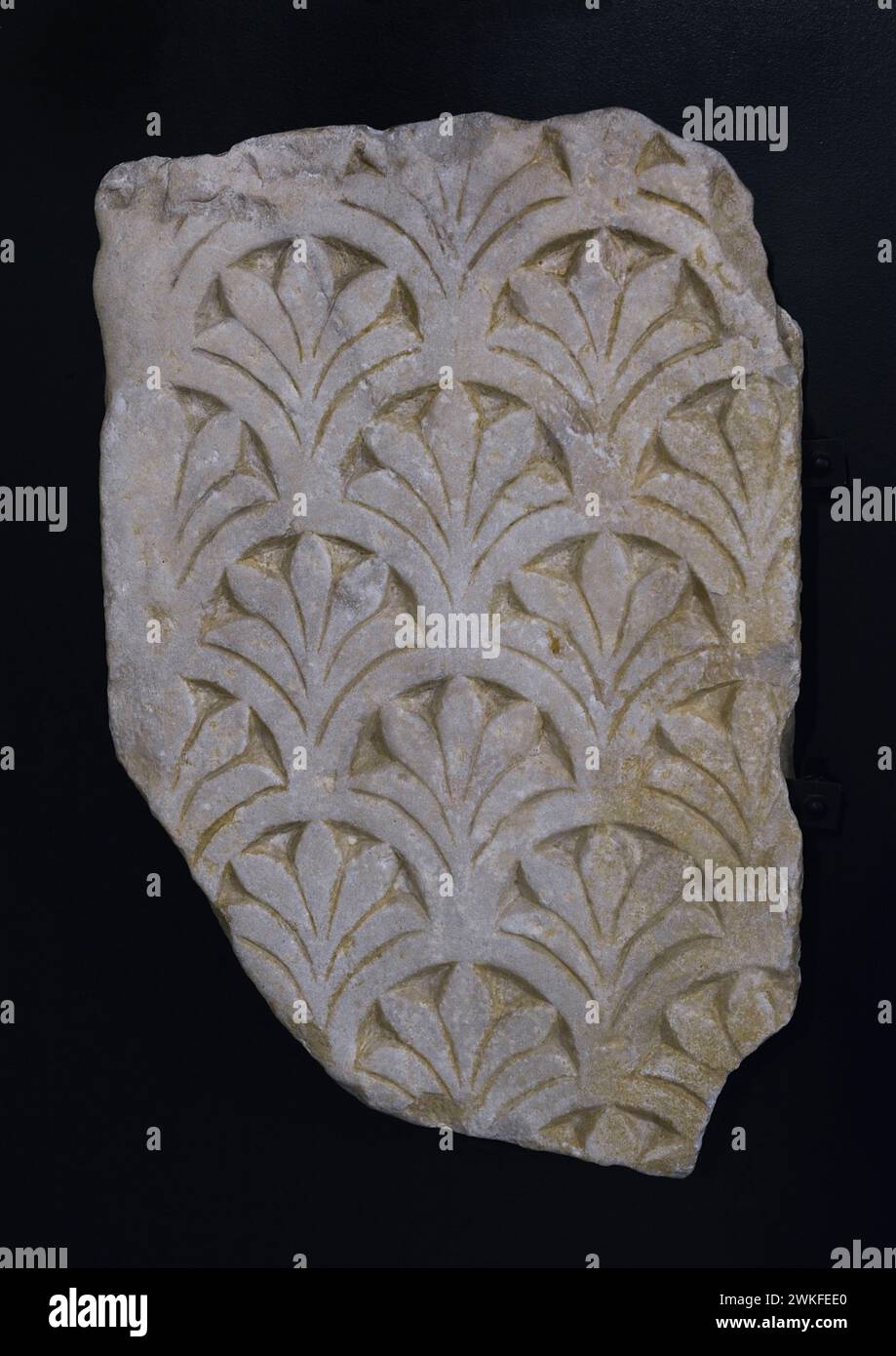 Plaque of chancel decorated with imbricated semicircles showing fleur-de-lis and palmettes. Marble. 7th century. Unknown provenance. Museum of Visigoth Councils and Culture. Toledo, Castile-La Mancha, Spain. Stock Photo