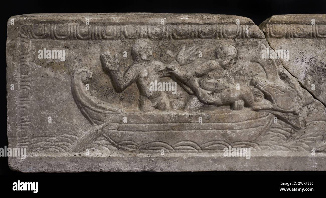 Sarcophagus of Jonah. Sarcophagus lid of an adult individual that was reused as part of the covering of the tombs of a Visigothic necropolis. It depicts the cycle of the prophet Jonah, in three consecutive scenes along the entire front. Detail of the fragment showing Jonah thrown into the sea and swallowed by the whale. Estremoz white marble. Late 4th century. From the Roman villa of Carranque, province of Toledo, Spain. Museum of Visigoth Councils and Culture. Toledo, Castile-La Mancha, Spain. Stock Photo