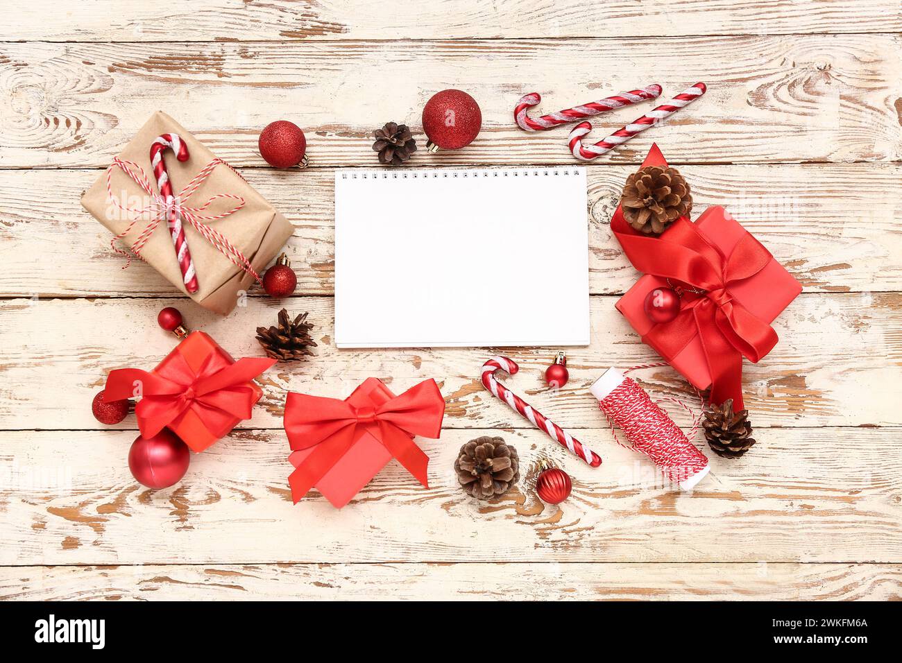 Blank paper calendar with gift boxes and Christmas decorations on white ...