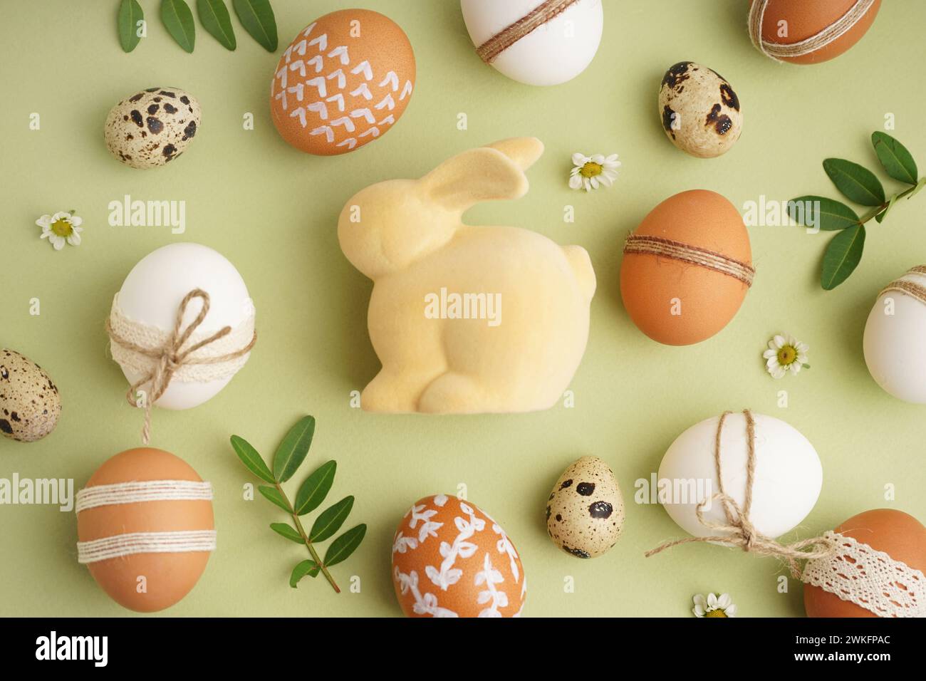 Decorated Easter eggs and toy bunny on green background Stock Photo - Alamy