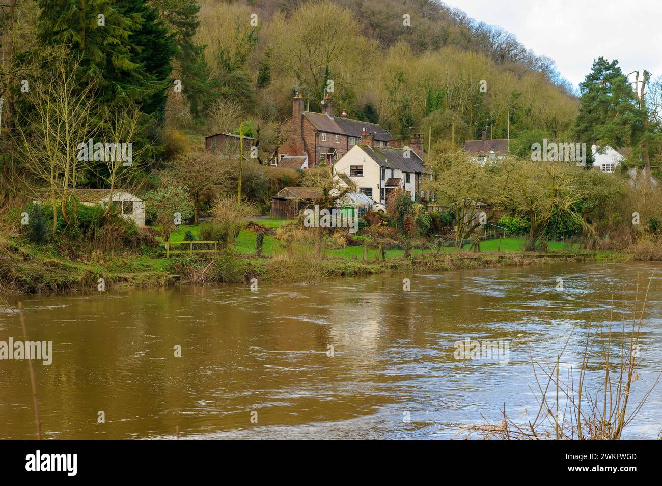 Houses on the banks of the River Severn on a sunny winter day, Ironbridge, Shropshire, England Stock Photo