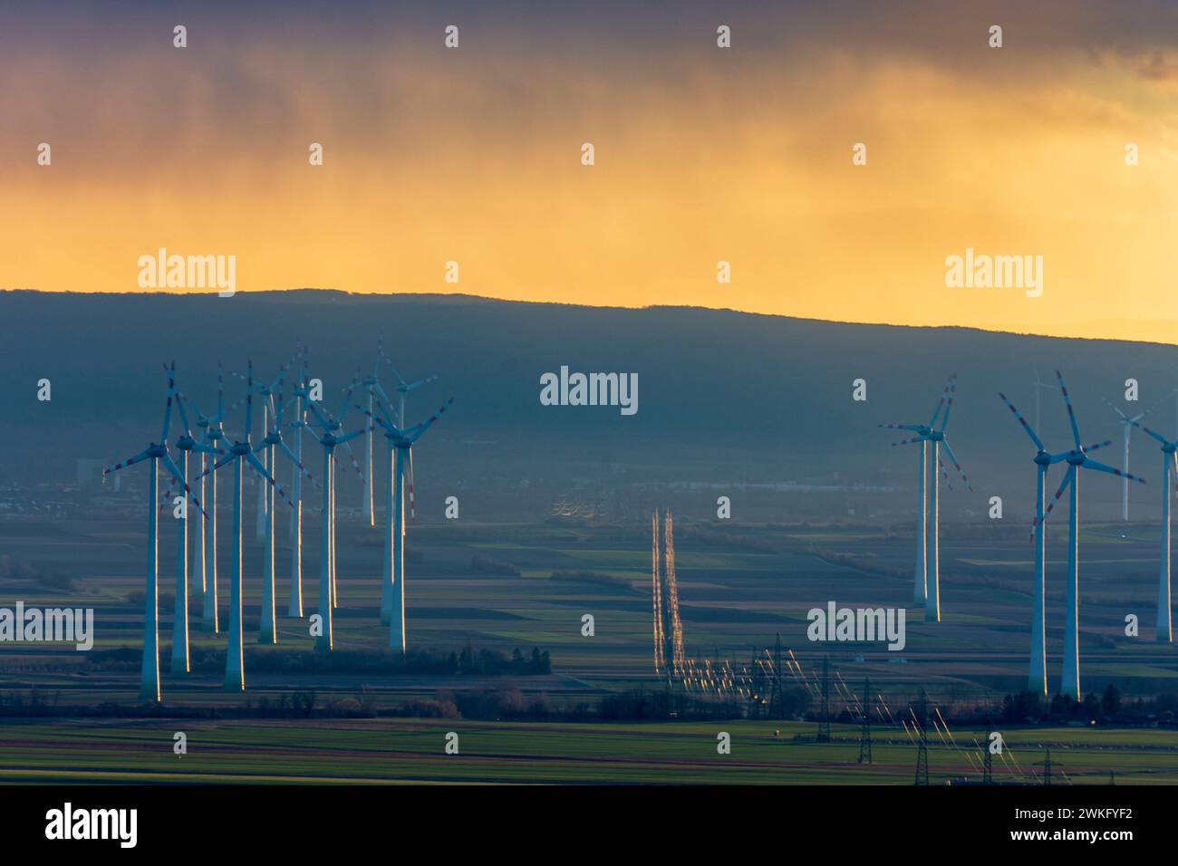 wind turbines, pylons of high voltage line, mountain range Leithagebirge, sunset Petronell-Carnuntum Donau Niederösterreich, Lower Austria Austria Stock Photo
