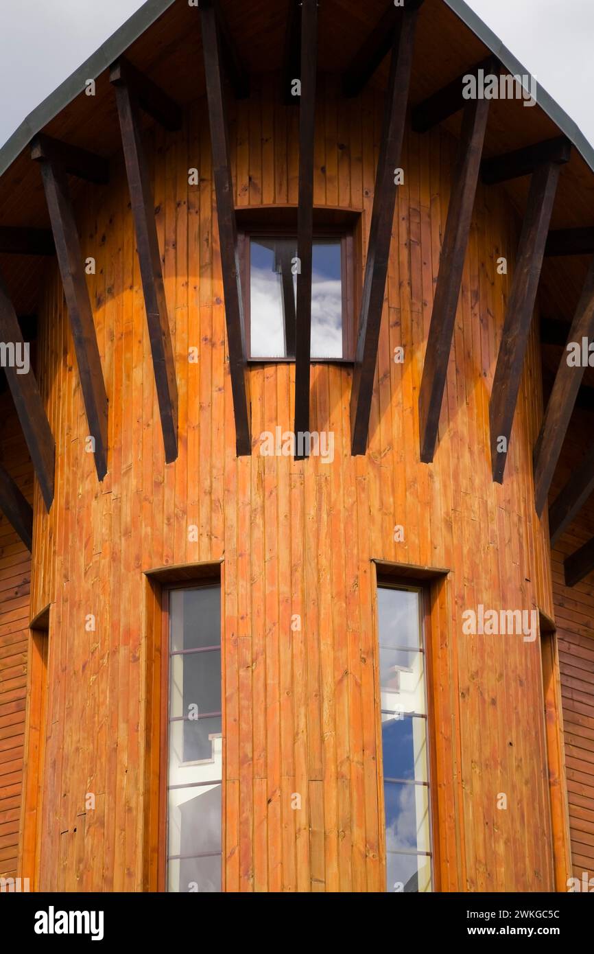 Timber and wood plank cladded residential building exterior with long narrow windows, Donovaly village, Slovakia Stock Photo