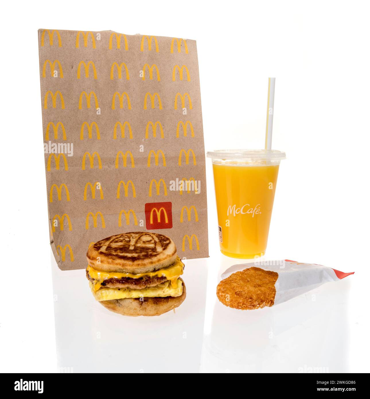 Winneconne, WI - 20 February 2024: A package of McDonalds breakfast including orange juice hashbrown and sausage egg cheese Mcgriddles on an isolated Stock Photo