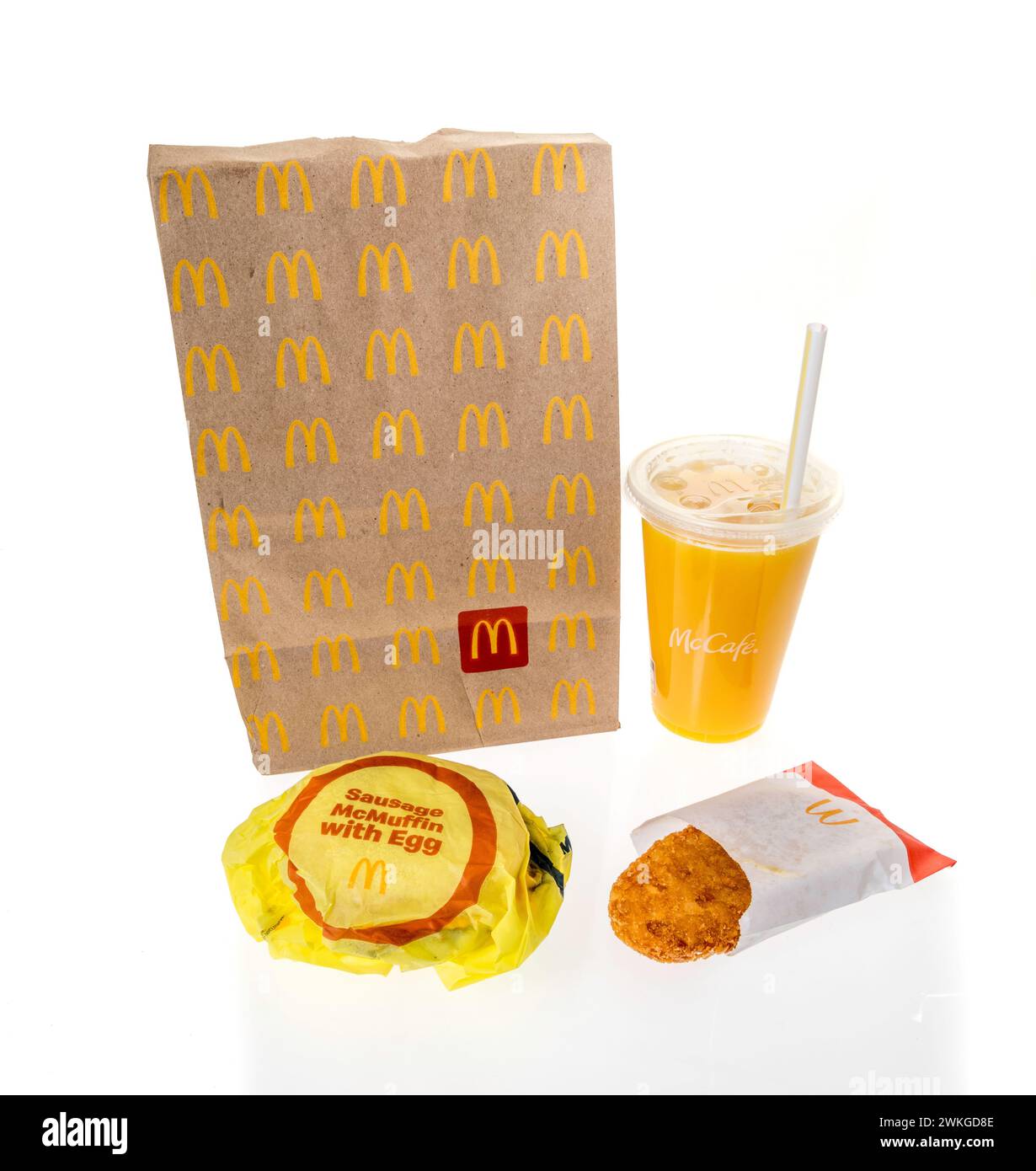 Winneconne, WI - 20 February 2024: A package of McDonalds breakfast including orange juice hashbrown and sausage egg cheese Mcmuffin on an isolated ba Stock Photo