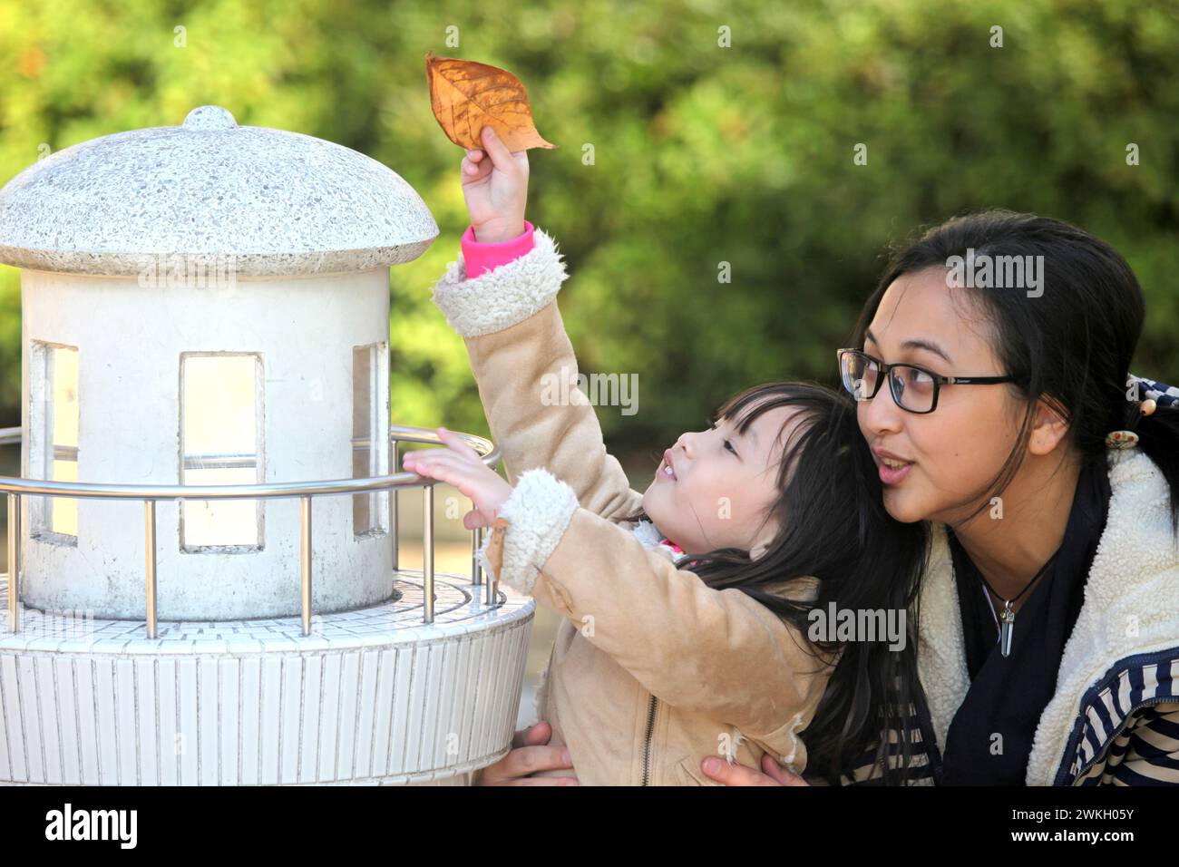 An Asian mother with her young daughter at Yokohama Park in Kanagawa Prefecture, Japan. Stock Photo