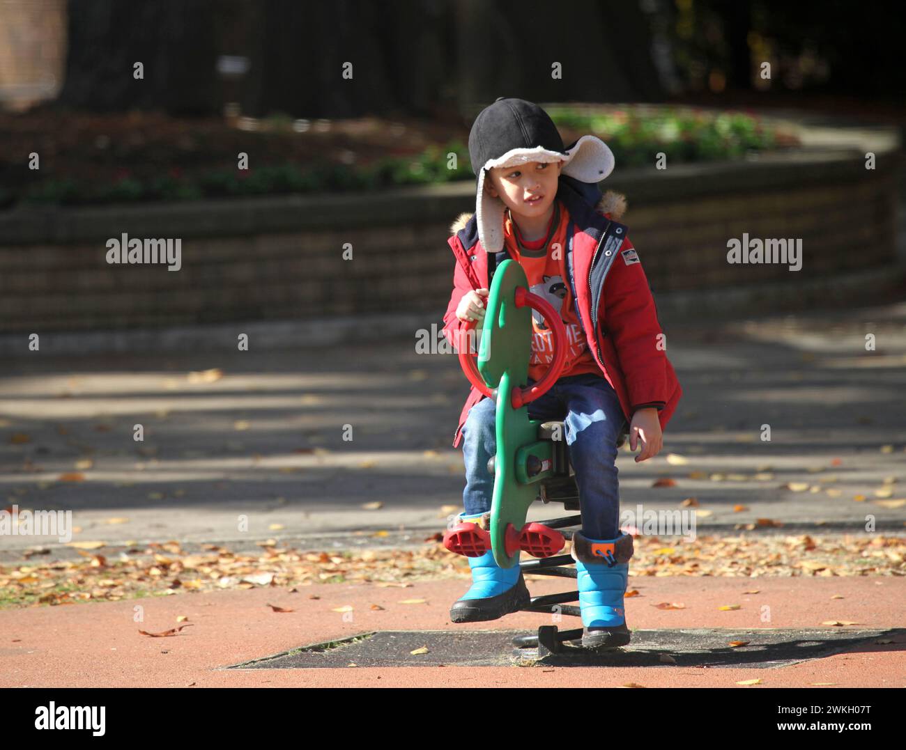 Young Eurasian Boy playing in a playground in winter, in Yokohama, Kanagawa, Japan Stock Photo