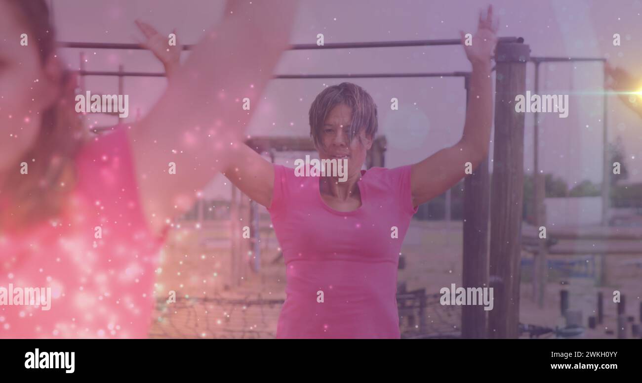 Image of light spots over diverse women at obstacle course exercising Stock Photo