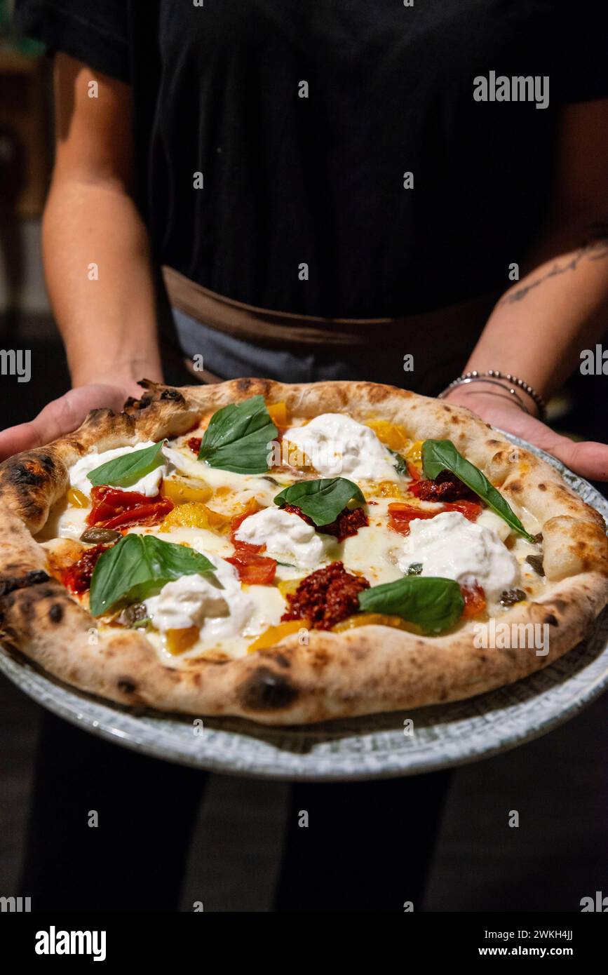 Pizza with burrata cheese, sun dried tomatoes and basil, Italy Stock Photo