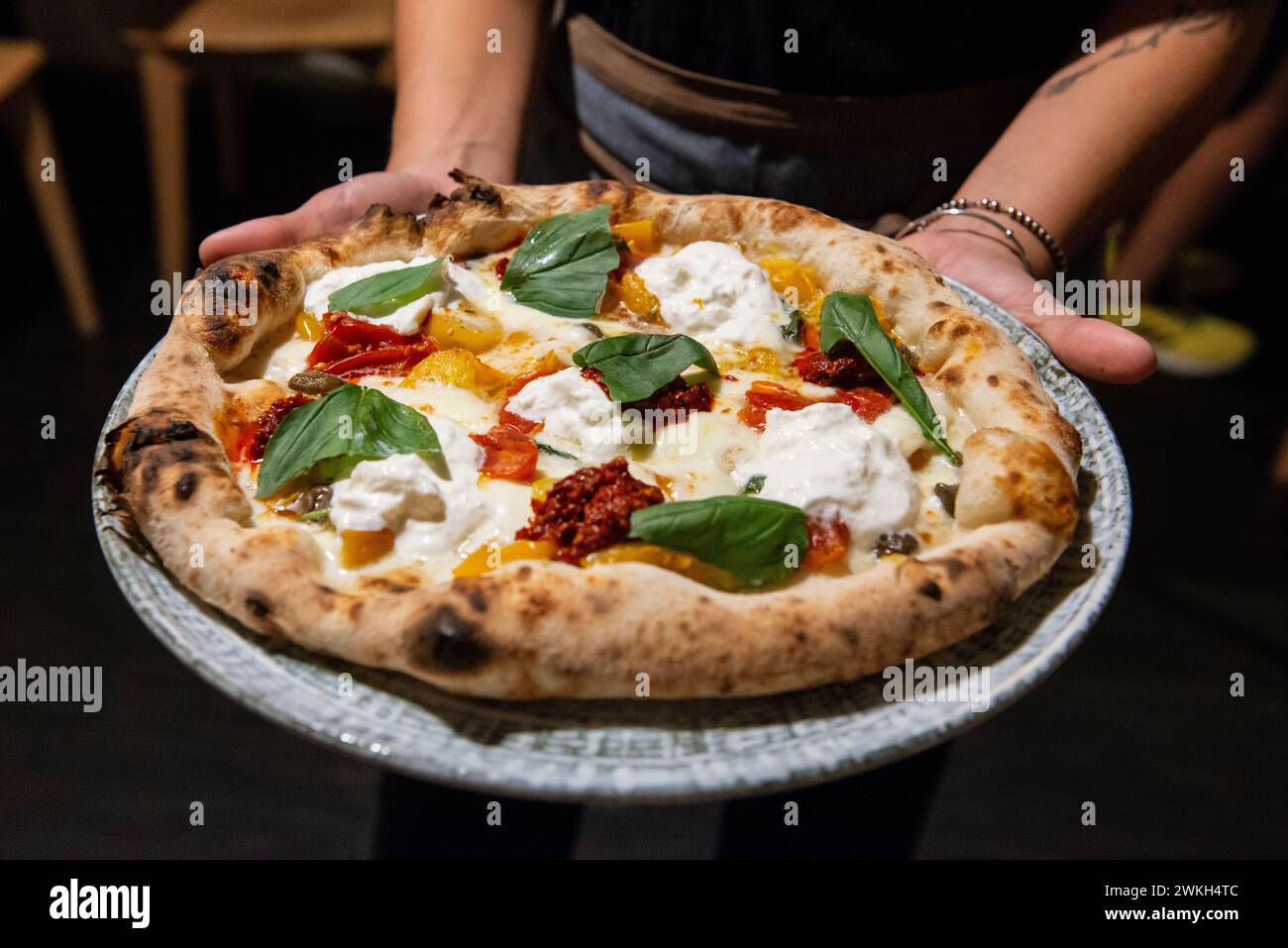 Pizza with burrata cheese, sun dried tomatoes and basil, Italy Stock Photo