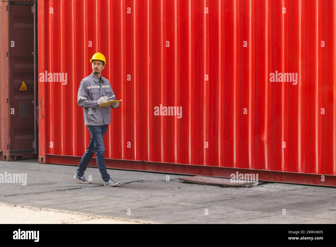 Cargo container yard working staff walk check looking for import export customs service team officer Stock Photo
