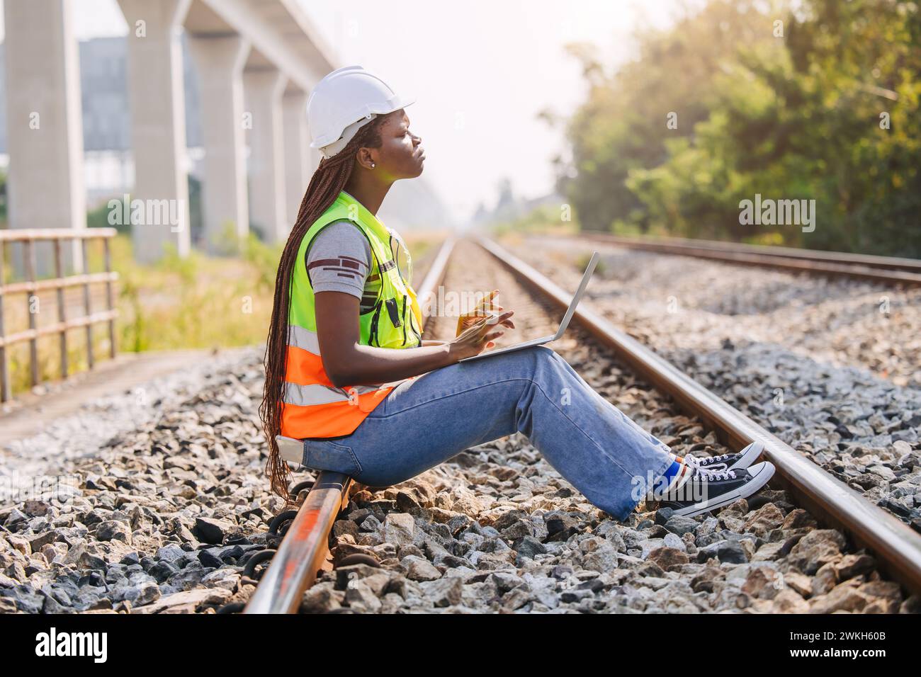 African black engineer women worker work checking service in train railway tracks construction site in transportation industry Stock Photo