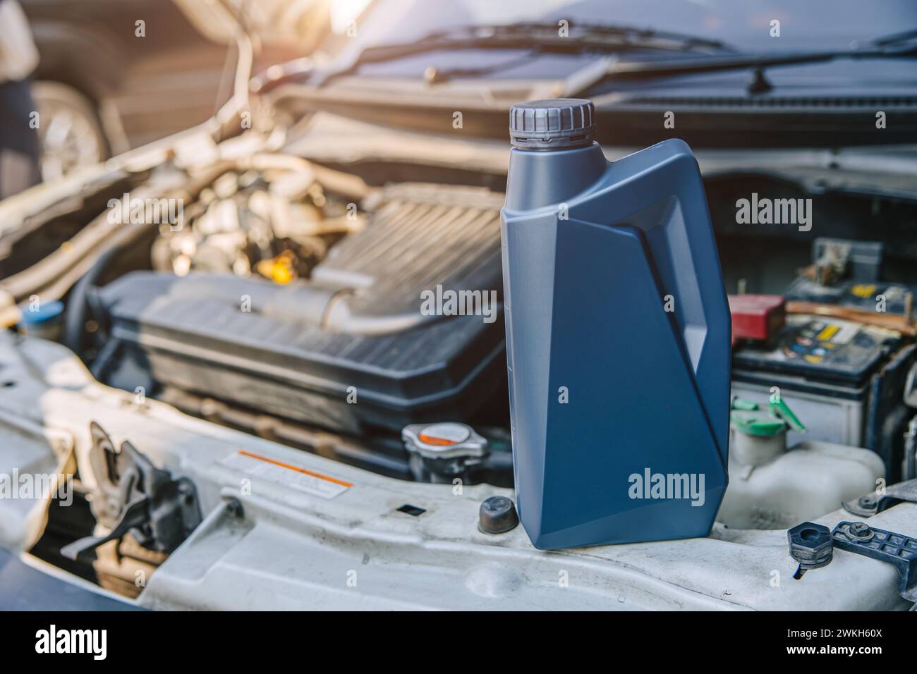 lubricant oil gear liquid with old car open hood engine for service