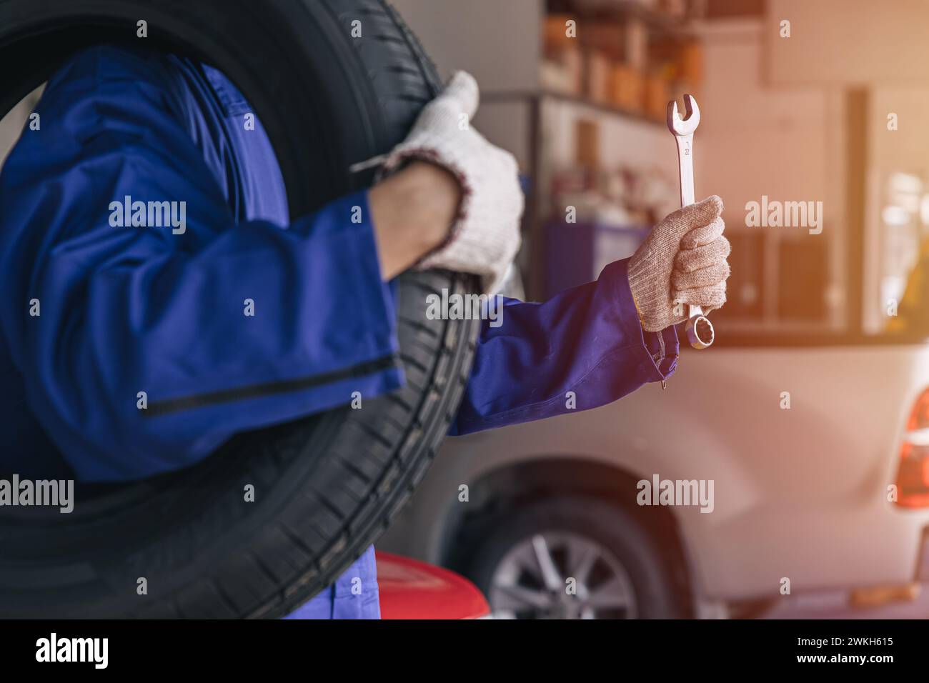 closeup garage mechanic worker replace car tyre change replace rubber wheels in auto service center concept Stock Photo