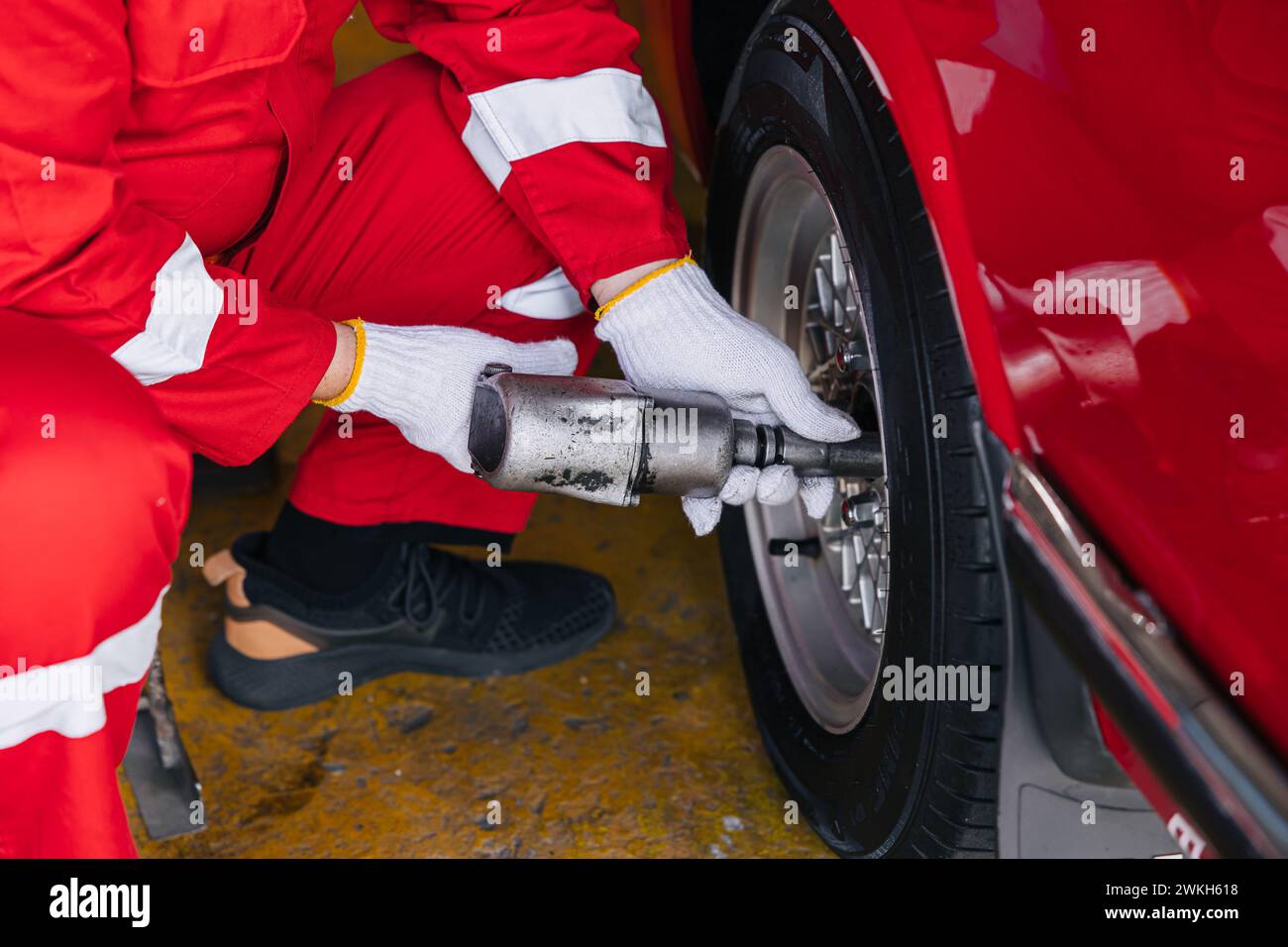 closeup garage mechanic worker replace car tyre change replace rubber wheels in auto service center concept Stock Photo