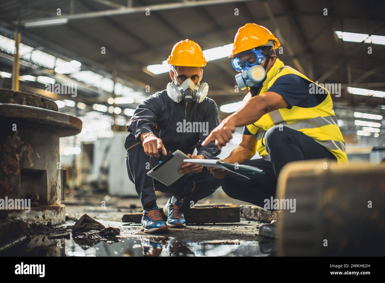 Toxic chemical gas leak safety team working cleaning in danger factory workshop environment contamination safety and protection Stock Photo