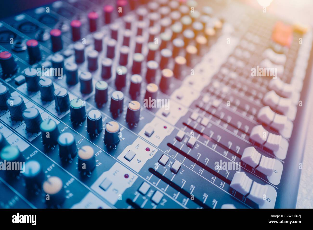 Closeup multi channel digital sounds mixer for voice recording. Sound engineer tools editor in studio or stage show instruments blue color tone Stock Photo