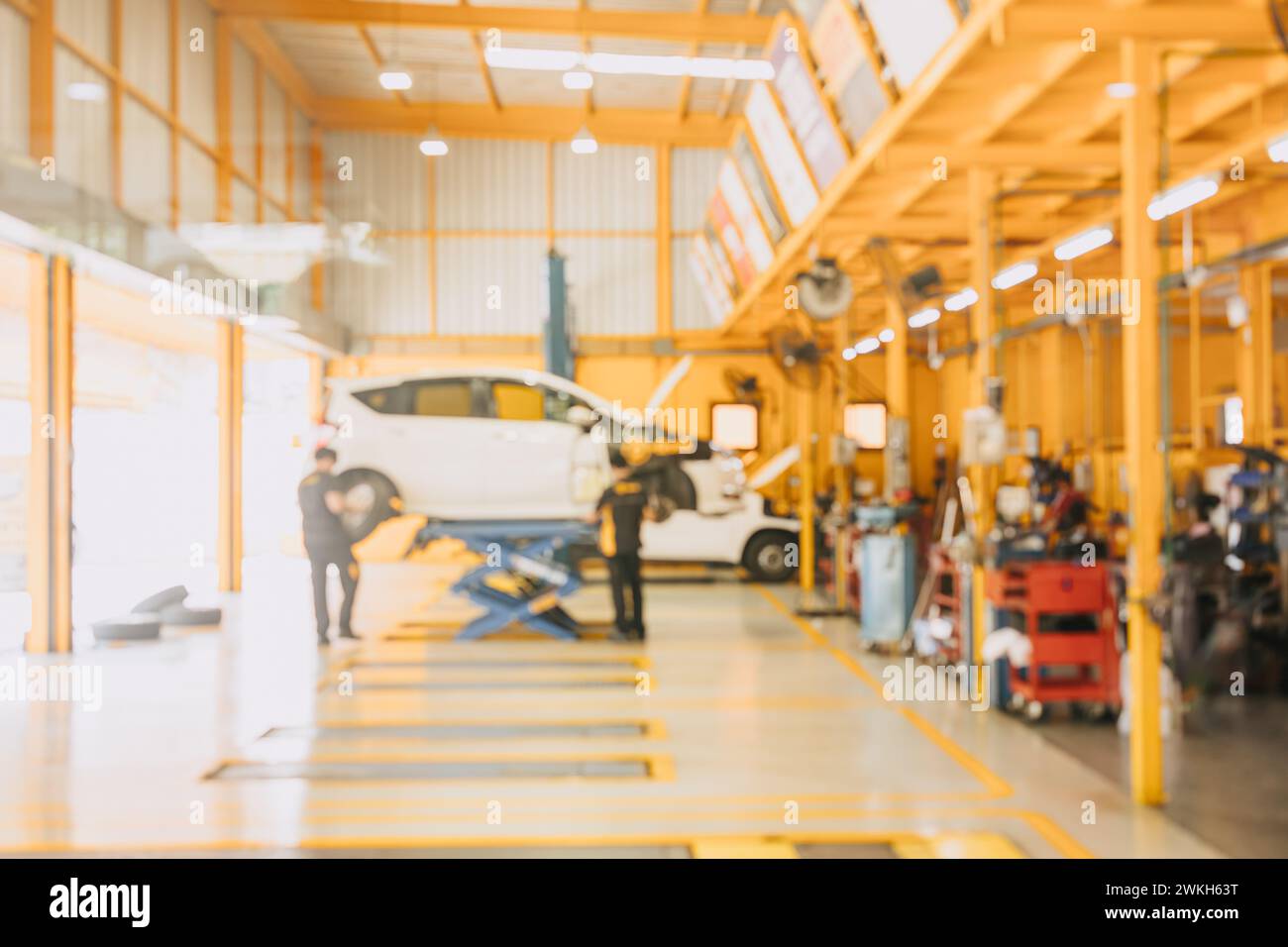 Garage car service center mechanic team worker working fix maintenance vehicle blur for background Stock Photo