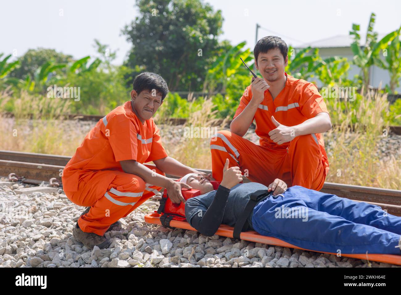 paramedic medical emergency doctor team working in action help first aid save people life at accident site outdoors Stock Photo