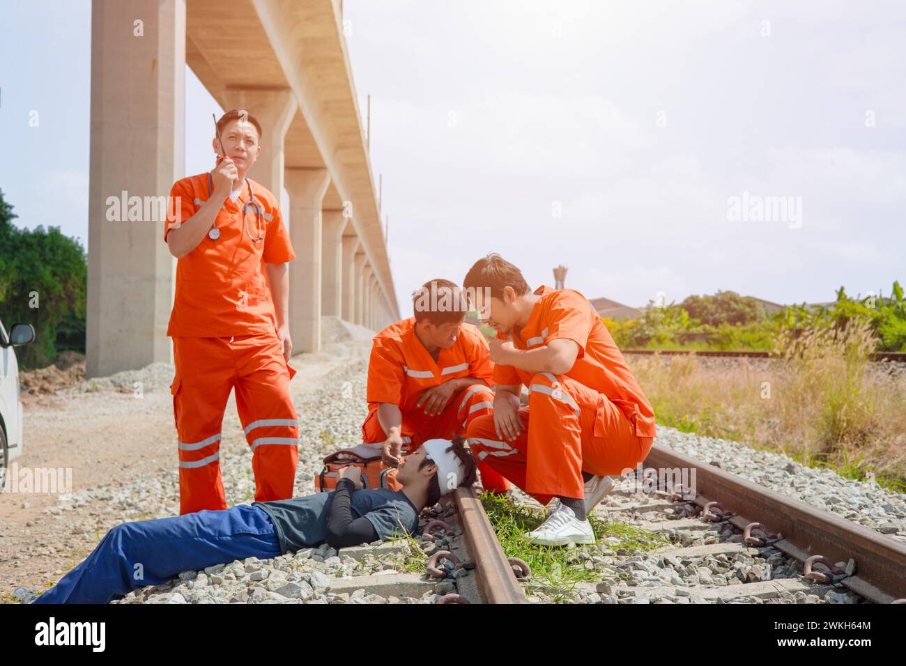 paramedic medical emergency doctor team working in action help first aid save people life at accident site outdoors Stock Photo