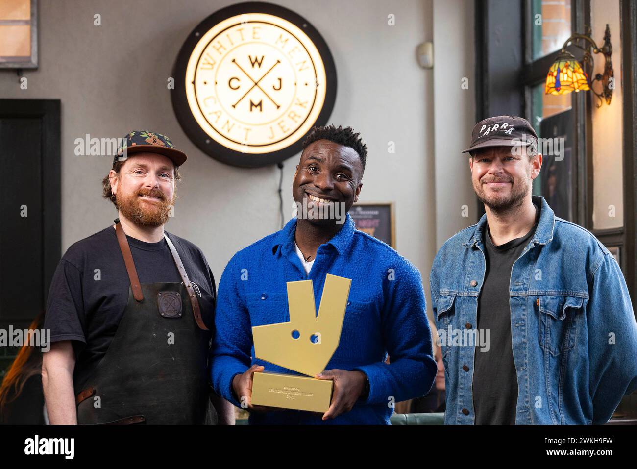 EDITORIAL USE ONLY Food critic, Jimi Famurewa (centre) with co-founders, Steve Byrne (right) and Dave Olszak at White Men Can't Jerk at the Prince of Peckham in London, as the restaurant is announced as the winner of Independent Restaurant of the Year Greater London 2024 in Deliveroo's 2024 Restaurant Awards. Issue date: Wednesday February 21, 2024. Stock Photo