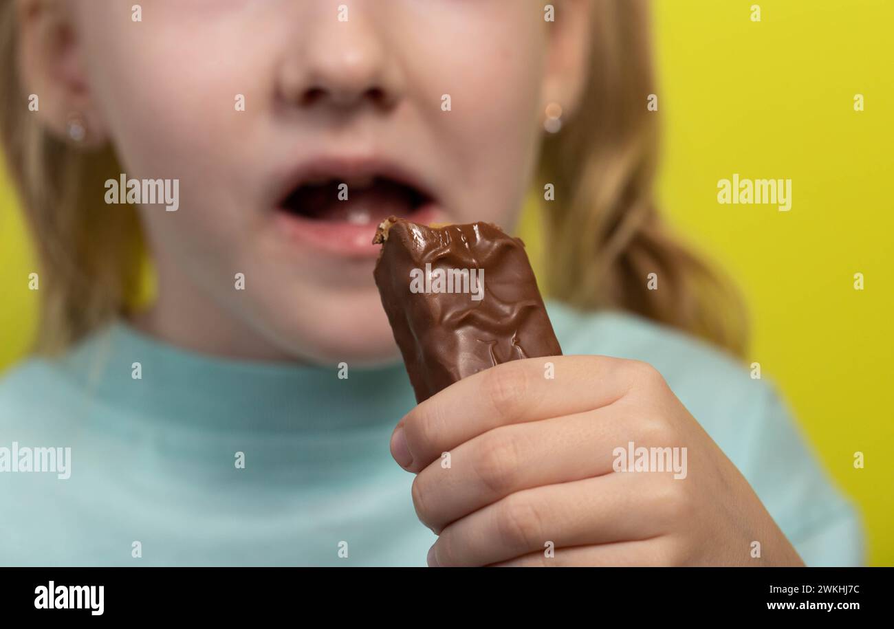 A seven year old little girl's dirty mouth from eating a candy bar. Diabetes mellitus and glucose, close-up Stock Photo