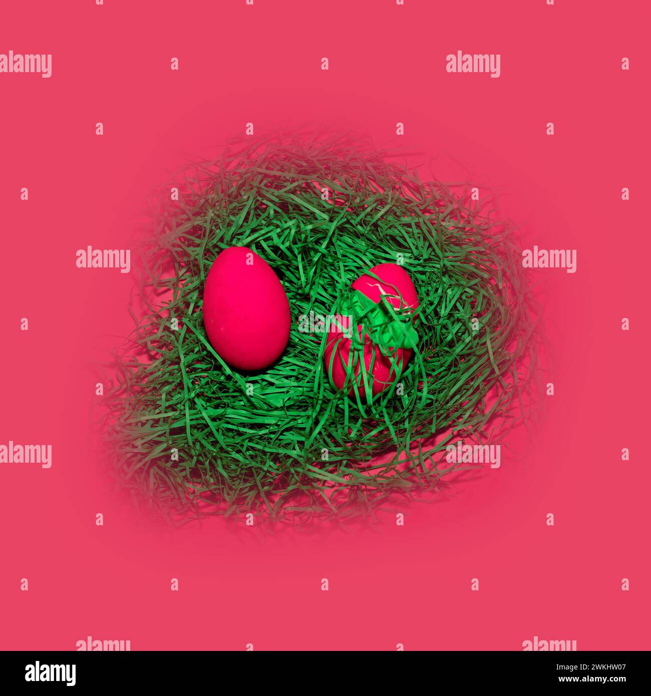Easter eggs in a nest of grass on a pink background Stock Photo - Alamy