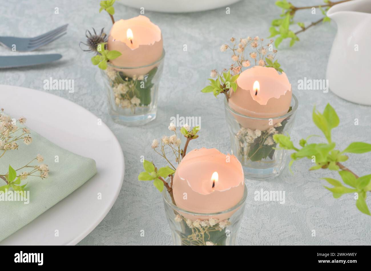 Easter, spring, hand made decoration on a table. Handmade candles from egg shells. Stock Photo