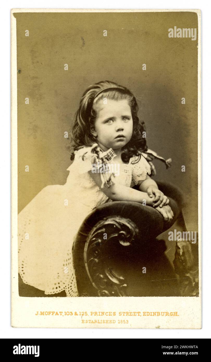 Original, charming Victorian Carte de Visite ( visiting card or CDV) of cute little young Victorian girl, Victorian child, named Annie Cranstoun Pitcairn, dated 1873 aged 2 years 5 months From the studio of John. Moffat 103 - 125 Princes Street, Edinburgh, Scotland, U.K. Stock Photo