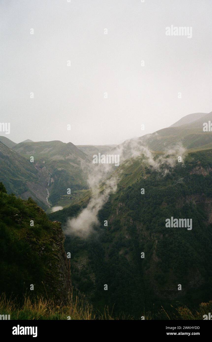 Clouds Dance Over Hidden Valleys: A Glimpse of Earth's Quiet Splendor Stock Photo
