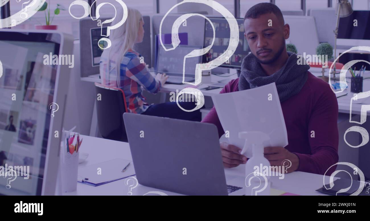 Image of question marks icons over diverse business people holding ...