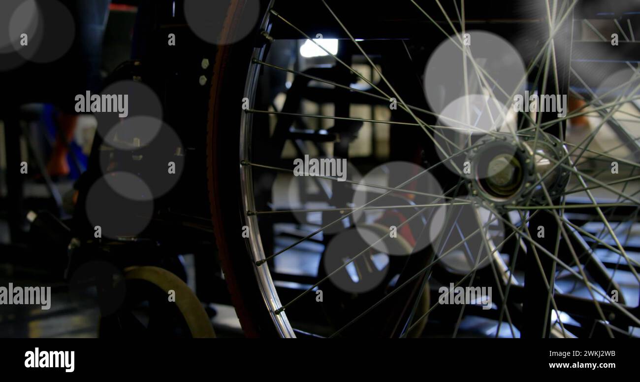 Close-up of a bicycle wheel in a dimly lit room Stock Photo