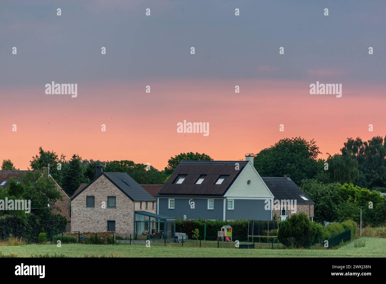Houses on the outskirts of a village under a summer twilight Stock Photo