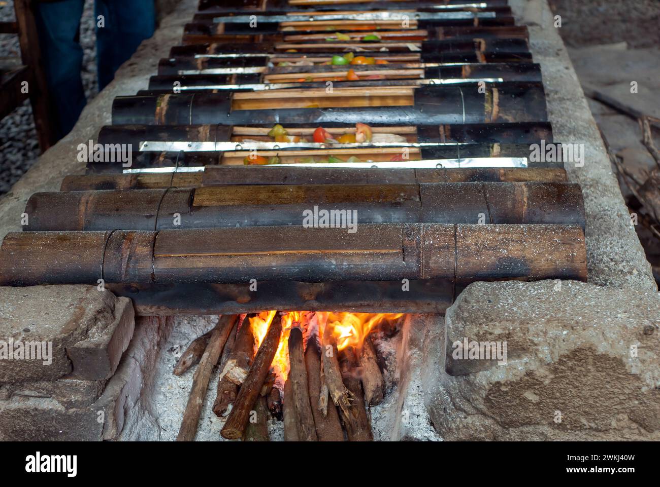 Garang asem, an Indonesian traditional food, delicious chicken cooked in burnt bamboo tube. Stock Photo