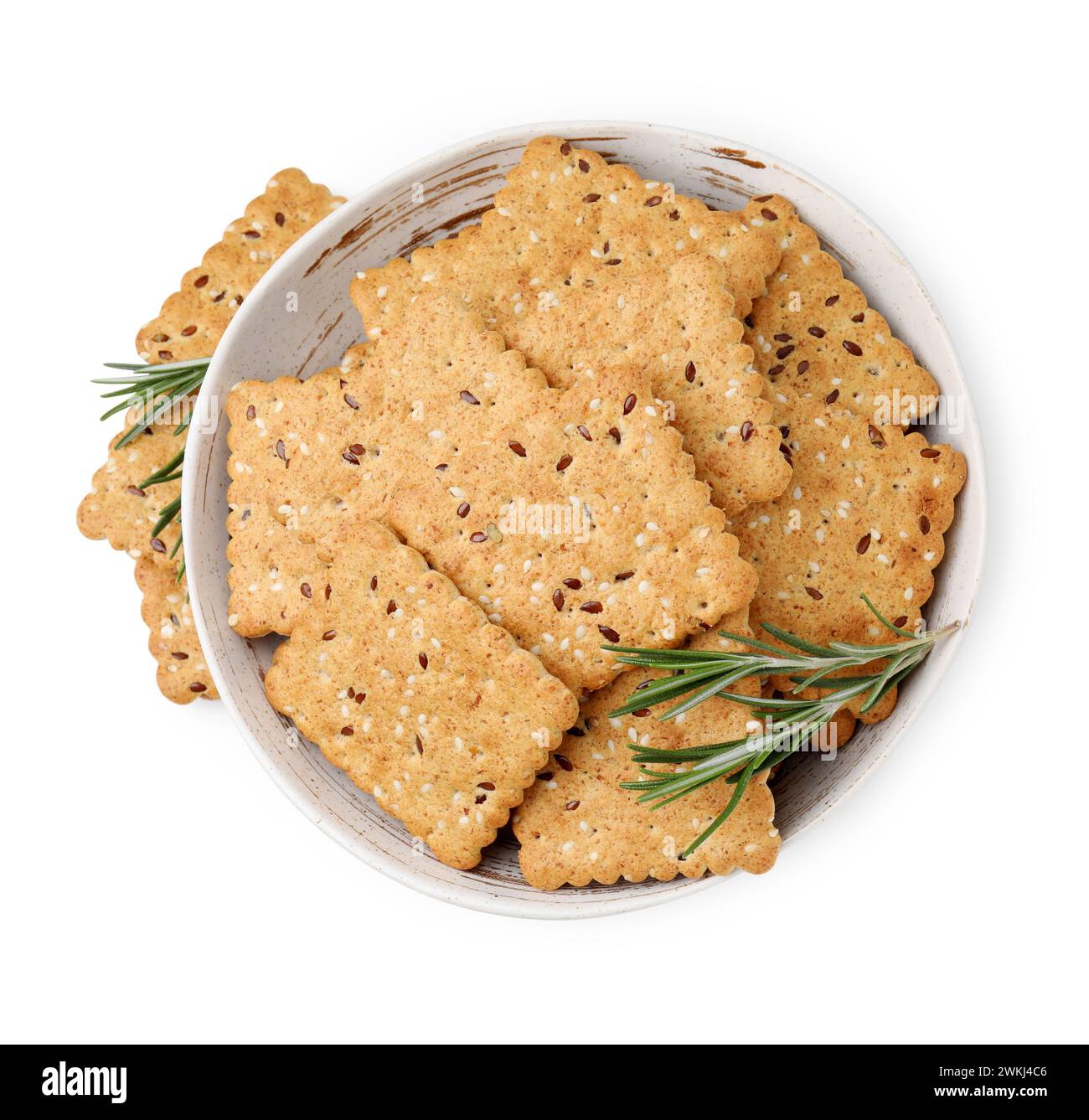 Cereal crackers with flax, sesame seeds and rosemary in bowl isolated ...