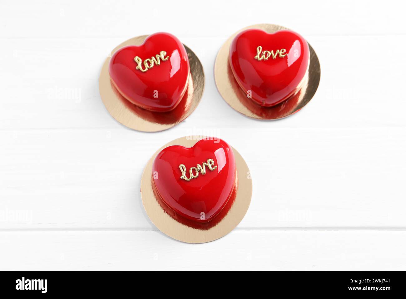 St. Valentine's Day. Delicious heart shaped cakes on white wooden table, above view Stock Photo